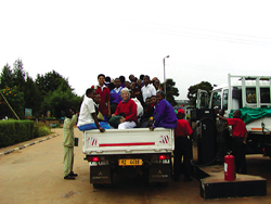 Betty Ann hitches a ride with other travelers. This is the usual mode of transport, second only to walking. Many Malawians will accept a ride and get on board if the vehicle is going their way.