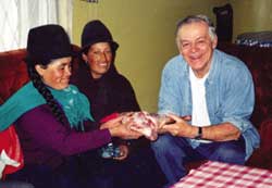 Receiving a cut of meat from women in the community who raise sheep.