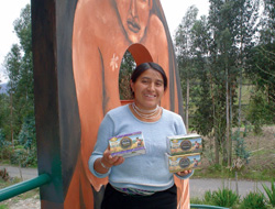 María Olivia, tea seller at Jambi Kiwa, with boxes of tea in front of the factory.