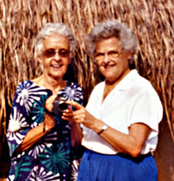 Sr. Patricia Kay (North Sydney, Nova Scotia) with Sr. Ruth Kidson of the Missionary Sisters of the Holy Rosary outside the roundhouse used for video editing. Sr. Ruth did the editing in the majority of videos they produced together in the 1990s. She was also Patricia's instructor in video-making and editing on the educational videos-biblical dramas and AIDS awareness documentaries-produced with the help of local young people. Vandeikya, Nigeria.