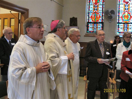 Archbishop Collins assisted by Fr. Jack Lynch and Deacon Tom McKeough