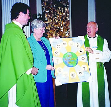 Fr. Gerald Curry presents Scarboro¹s Golden Rule poster to Fr. Paul MacNeil and Sr. Millie MacNeil, chaplains at St. Francis Xavier University, Nova Scotia.