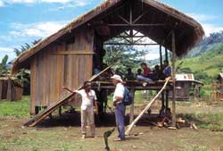 Fr. Charles Gervais passes through a Manobo village in the hills of Mindanao, Philippines.