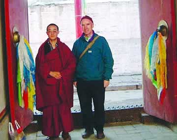 Fr. Brian Swords visits with a Buddhist monk in Tibet.