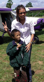 A confident Ou after his plane ride, accompanied by June, a caregiver at the Camillian Centre where Ou lives. Rayong, Thailand.