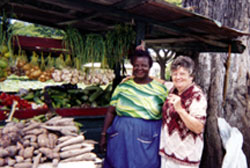 A Guyanese market vendor proudly displays her produce to Sr. Mary Gauthier. Sr. Mary's experience of mission has been one of blessing and learning, accompanying those in developing countries who struggle for life and dignity as children of God.