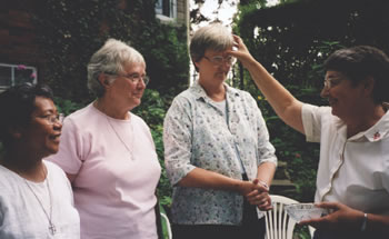 Former leadership team member Sr. Joan Missiaen blesses the newly elected leaders of Our Lady's Missionaries, L-R: Sr. Norma Samar, Sr. Rosemary Hughes and congregational leader Sr. Frances Brady at their central house in Toronto.