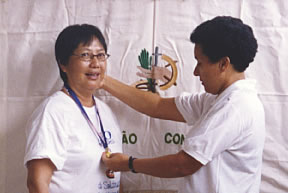On behalf of the community Centre's day program for people suffering from AIDS. Irma Deuse presents a gold medal award to Sr. Lucia Lee in appreciation of her dedicated service for the past five years. Fortaleza, Brazil.