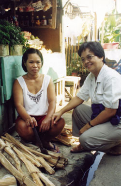 Sr. Yol Cadavos (right) visits with Ellen Cagas at her home. Not long after this visit, Ellen's was one of 320 homes that burned to the ground in a neighbourhood fire.