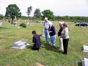 Sadaoki (Sam) Okada with members of the Cox family at the gravesite of Scarboro missioner Fr. Mike Cox. Glace Bay, Nova Scotia.