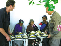 Scarboro missioners Barbara Heshedahl and Mike Hiebert working with volunteers to prepare meals for the elderly poor in Riobamba