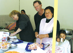 Scarboro missioners Barbara Heshedahl and Mike Hiebert working with volunteers to prepare meals for the elderly poor in Riobamba