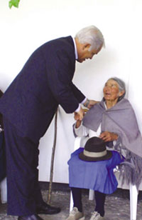 Bishop Victor Corral of Riobamba Diocese greets the elderly and the volunteers who serve them each Saturday in the courtyard of the cathedral.