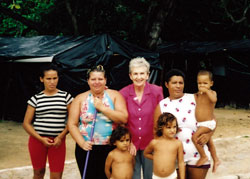Sr. Clarice Garvey with members of a community of 300 families who had camped under black plastic tents on the roadside for more than a year while awaiting legal possession of land.