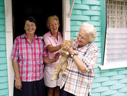 L-R: Sr. Joan Missiaen, Scarboro lay missioner Kate O'Donnell, and Sr. Doris MacDonell with a little feline friend. New Amsterdam, Guyana. 