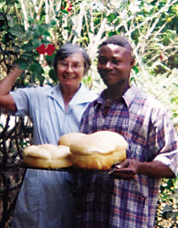 Sr. Gwen Legault writes: 'When the cares of my heart are many, your consolations cheer my soul' <i>(Psalm 94:19)</i> ...simple consolations like teaching a new bread recipe to Francis Zenda (pictured with Sr. Gwen) or admiring a hibiscus in full bloom outside our kitchen. Since her retirement from teaching at St. Francis School for the Deaf and Blind, Sr. Gwen has been working with the St. Vincent de Paul Society to help those most in need in the community. She also brings the Eucharist to shut-ins and visits the lonely. Vandeikya, Nigeria.