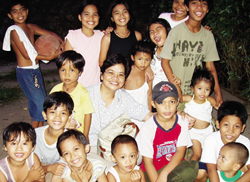 Sr. Yolanda Cadavos with the children's prayer group of Bitan-ag Village, Cagayan de Oro City.