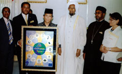 The Interfaith Peace-Building Initiative (IPI) presents the Indonesian Ambassador to Ethiopia with IPI's Goodwill Ambassador of Peace award, which includes a framed Scarboro Missions Golden Rule poster.  L-R: Mr. Yusuf Hassen (Islam); Mussie Hailu, Board Chair of IPI; Indonesian Ambassador Dr. Alwis Azizat Murad (Islam); Haji Oumer Idris, Chairman of Addis Ababa Islamic Affairs Supreme Council; Kesis Kefyalew Merahe, Orthodox Christian priest, and Sr. Laetitia S. Borg (Catholic). Ethiopia.