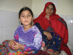 Doing exercises with a patient who is accompanied by members of her family. Credit: Nancy Stephens