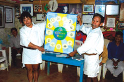 Two Mayan spiritual leaders in the village of Acteal hold Scarboro Missions' Golden Rule poster. Chiapas, Mexico. Credit: Vince Ramcharran