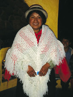 Manuela Gualancanay, an Indigenous woman in Ecuador wears a shawl knitted by Fr. Bob Cranley. Always hoping to one day knit with alpaca wool, Fr. Bob loved to speak with missioner Tom Walsh about Manuela and the women's income-generating project to knit alpaca wool scarves, hats and mitts for sale. When he heard sales had slackened, Fr. Bob thought this shawl would be a good seller in Canada and sent it as a model to Manuela. She immediately began knitting the shawl with alpaca wool, but Fr. Bob died before she could complete it.