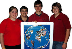 Left L-R: Kaylee Beaulieu, chaplain Sr. Terry Wilson, David Hallett and Katrina Jansen. These St. Joseph's high school students travelled to Scarboro missioner Fr. Lou Quinn's parish in San Jos. de Ocoa, Dominican Republic, in March 2006. The map holds pictures of children from Ocoa that St. Joseph's students have met since Sr. Terry began taking them there in 1995.