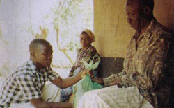 Members of the Young Christian Students group of St. Patrick's Seminary bag and distribute maize flour to people affected by food shortages in their communities.  Mzuzu, Malawi.