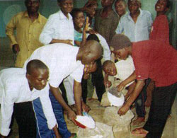 Members of the Young Christian Students group of St. Patrick's Seminary bag and distribute maize flour to people affected by food shortages in their communities.  Mzuzu, Malawi.