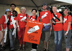 Child poverty activist Lauel Rothman (centre with placard), Coordinator of Campaign 2000, with other volunteers at the July 2005 Live 8 concert in Barrie, Ontario.