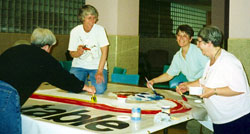 Sisters of St. Joseph and friends working on the G8 summit sign.
