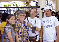Members of a local dialogue group, and organizers of the walk, participate in a Walk for Peace, L-R:  Ellen Red, Our Lady's Missionary Sr. Mary Gauthier, Msgr. Rey Monsanto (Vicar General of the Archdiocese of Cagayan de Oro), and Mohamad Gondarangin (President of a local mosque). Cagayan de Oro, Philippines.