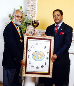 Mussie Hailu (right), board chair of the Interfaith Peacebuilding Initiative in Ethiopia presents the 2006 Golden Rule Peace Medal and mounted Golden Rule Poster to Dr. Hizkias Assefa, founder and co-coordinator of the African Peacebuilding and Reconciliation Network in Nairobi. Dr. Assefa has conducted peacebuilding training seminars and workshops in more than 50 countries of the world. He has lectured on reconciliation, peacemaking and conflict resolution in universities in Africa, Europe, Asia, North America, and Latin America.