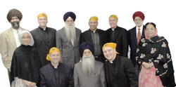 Representatives from the United States Catholic Conference of Bishops and the World Sikh Council (America Region) meet in New York for the first Catholic-Sikh national consultation in US history. The Vatican was represented by Monsignor Felix Machado (third from right, back row), Under-Secretary of the Pontifical Council for Interreligious Dialogue. Visitors to a Sikh temple must remove their shoes and wear a head covering as a sign of respect for God.