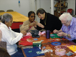 Nagulambikai Navaratnam, Sivasothy Velauthatillai and Lorraine enjoy each other's company while working on their creations.
