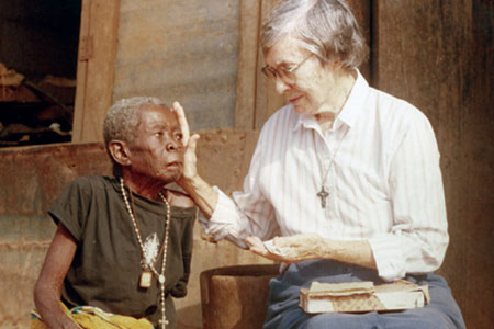 Cecelia Mbazendan Akile receives the Eucharist from Sr. Gwen Legault at her compound. Sr. Gwen quotes an African proverb: 'A real friend is one who comes when your house is on fire, not one who comes at harvest time!' to describe the type of friend she has tried to be to Cecilia ever since Cecelia fell on the fire she keeps lit in her hut for warmth. Fortunately her hut was spared but it has taken weeks of daily care to heal the serious burns on her leg and thigh. Sr. Gwen says, 'Cecelia is one of many shut-ins who need our presence and services. I am grateful for this privilege of helping her and for the friends of Our Lady's Missionaries who have made this possible.' After more than 30 years of ministry among the people of Vandeikya, Nigeria, Sr. Gwen has now returned to Toronto.