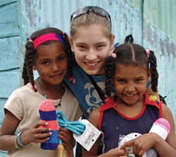 Two young Ocoans happily anticipate playing with new toys received from Kristin and other student volunteers.