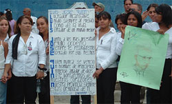 Women hold up signs honouring Padre Luis along the funeral procession route. He was an advocate for the rights of women, for farmers struggling to support their families, for children's health and education. In word and action, he witnessed to the Gospel message of a full life for all.