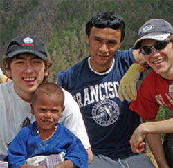 Little Darius makes friends with Chris, Nicco and Steve, D.R.E.A.M.S. participants from St. Mary Catholic Secondary School who volunteered in Ocoa building a home in his mountain community.