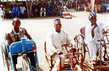 Emmanuel, Donald and Ganger take part in the wheelchair races during the celebrations for the World Day for the Disabled. Vandeikya, Nigeria.
