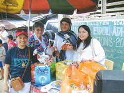 Srs. Lorie Nuñez and Mary Gauthier and other members of the interfaith dialogue group take part in gift giving on the Muslim festival of Eid al-Adha.