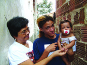 Sr. Yolanda Cadavos visits with Maiara and her daughter Andresa. The picture was taken by Suzana Barbosa who visited in Brazil, spending time with children in urban poor areas.