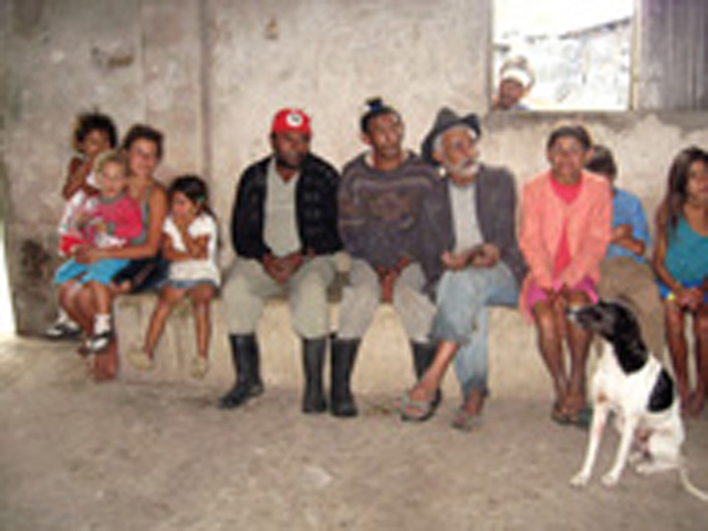 Pausing from their day’s work, the people gather in their community centre to welcome us and share stories of their struggle for land.